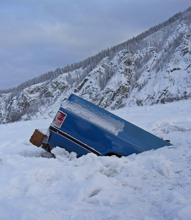 The car half buried in the ice on Alaskan lake