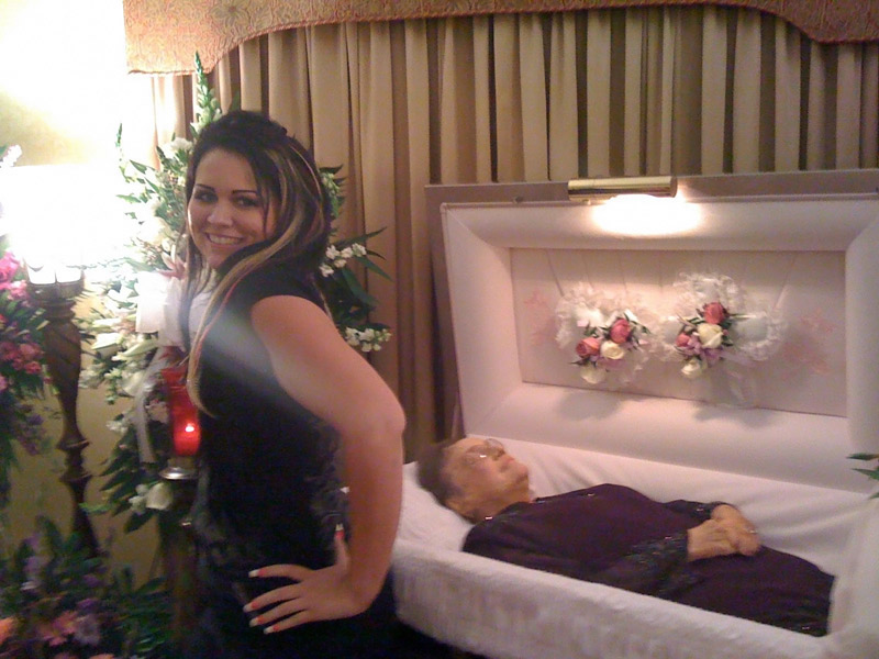 The girl is modeling by the coffin of her grandma