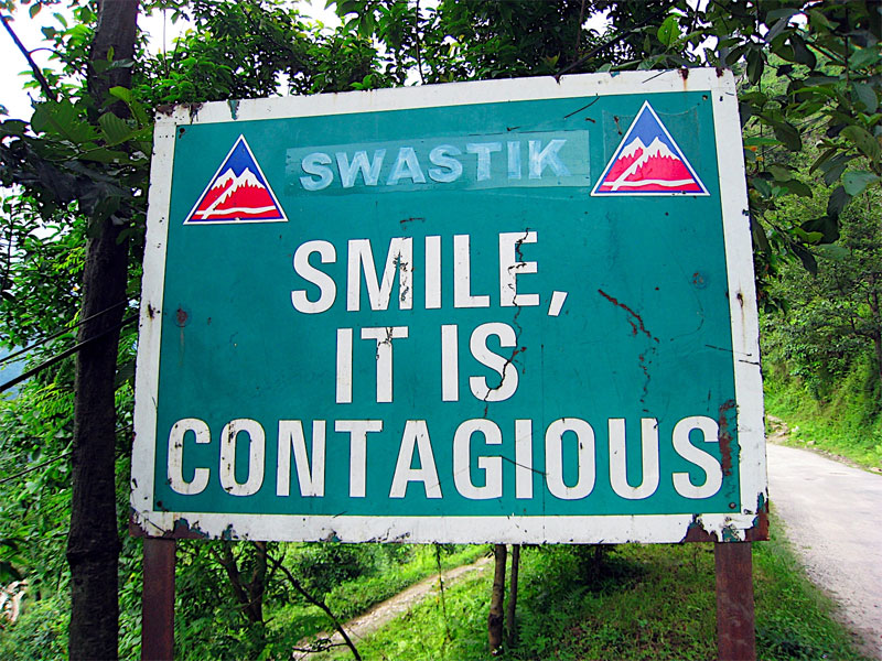 road sign: smile, it is contagious