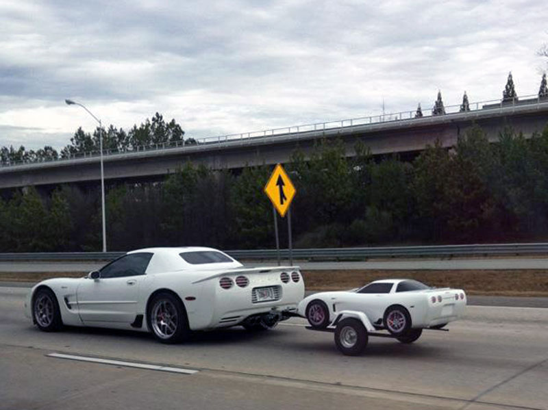2. White Corvette is towing the baby Corvette